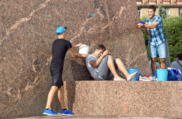 Teenagers playing with water guns.